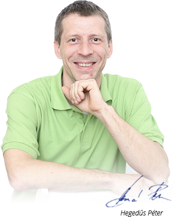 A smiling adult man with short dark hair wears a pale green polo shirt against a plain white background. He faces the camera and rests his chin on one hand while his other arm crosses in front of him. The crop runs from his head to his upper torso, with his forearms extending along the lower edge. A blue handwritten mark appears near the lower-right edge, but it is too small to read.